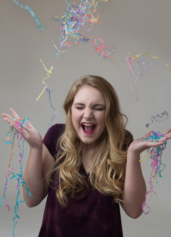 blond girl throwing confetti